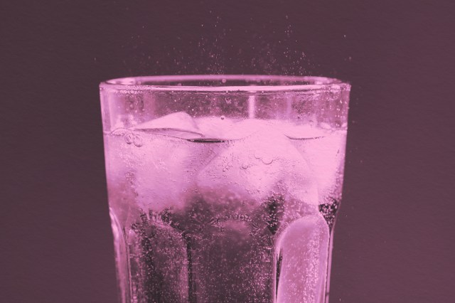 Glass of refreshing soda drink with ice cubes