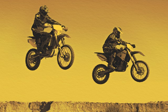 Action shot of two dirt bikers mid-air.