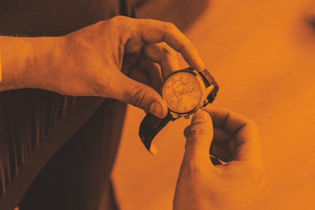 Close-up of checking the time on a watch
