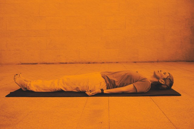 Woman laying on yoga mat