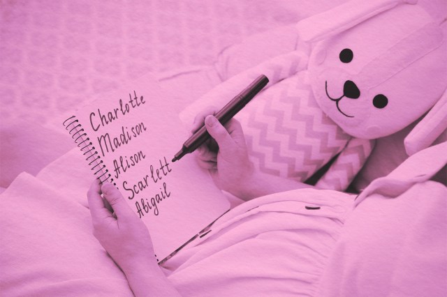 Pregnant woman with baby names list sitting in armchair