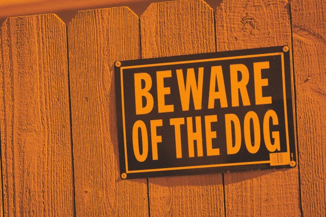 Beware of dog sign on fence