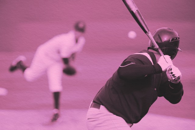 A baseball player ready to swing his bat during a pitch