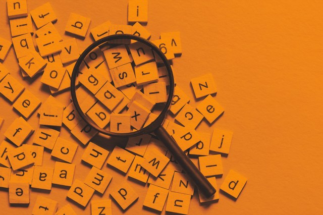 Square wooden tiles with the English alphabet scattered