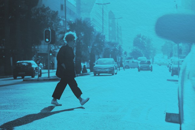 Woman crossing a busy intersection
