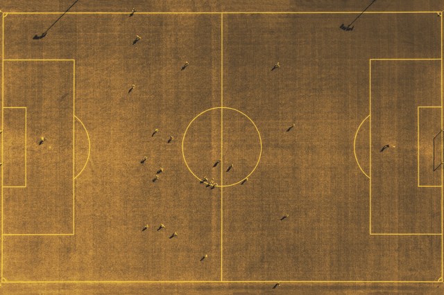 Aerial view of football field with player silhouettes