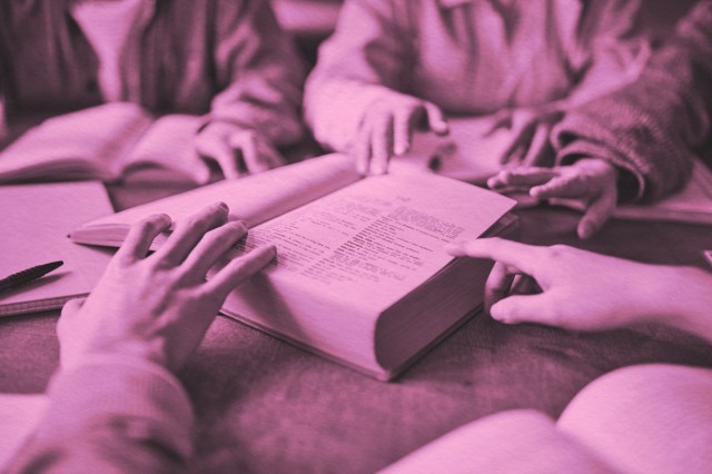 Close up of students going through dictionary