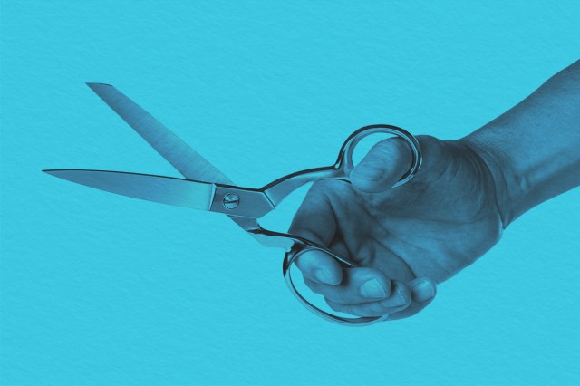 Hand holding pair of scissors